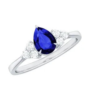 Pear Shaped Created Blue Sapphire Solitaire Ring with Diamond Trio