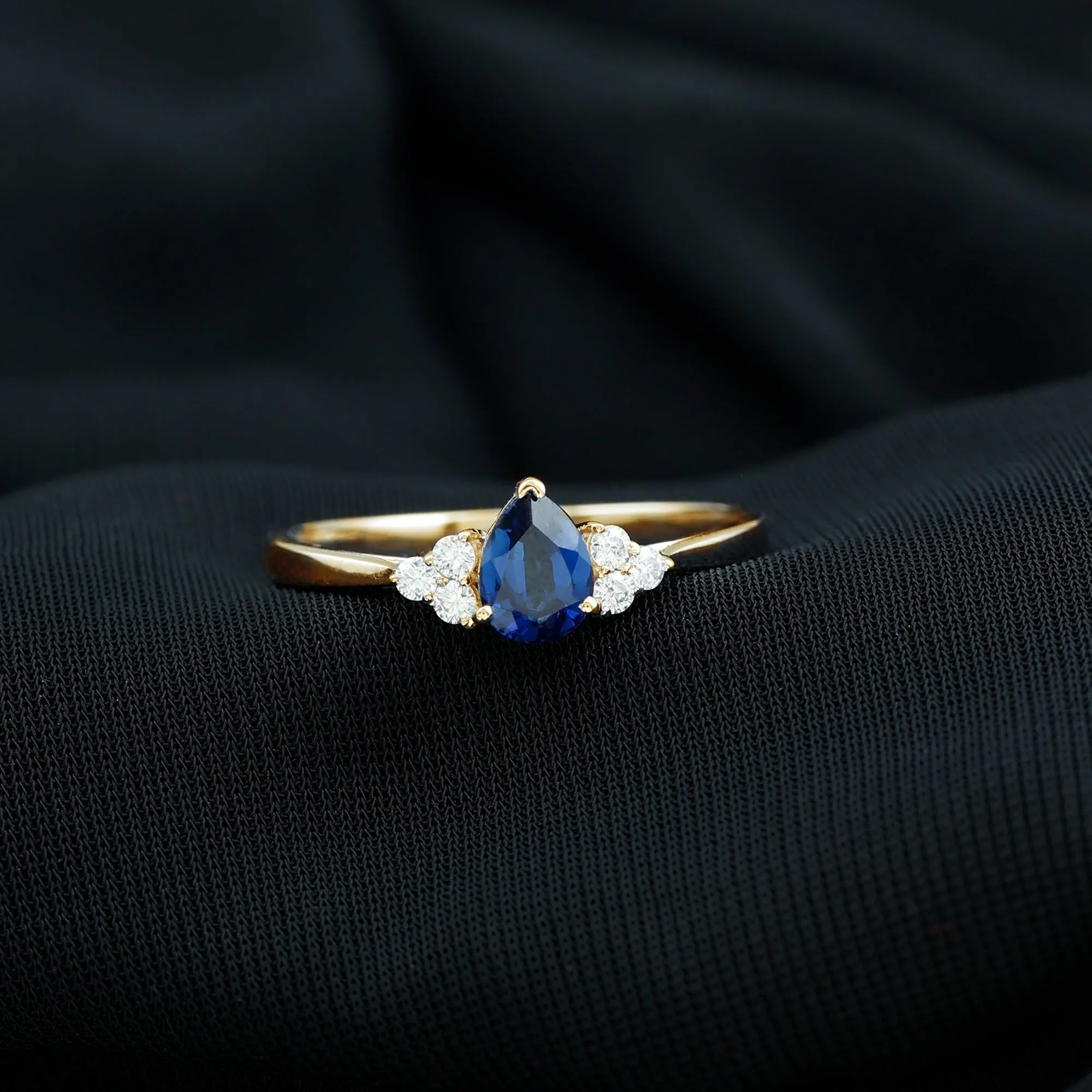 Pear Shaped Created Blue Sapphire Solitaire Ring with Diamond Trio