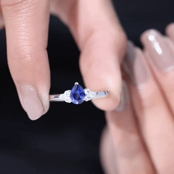 Pear Shaped Created Blue Sapphire Solitaire Ring with Diamond Trio